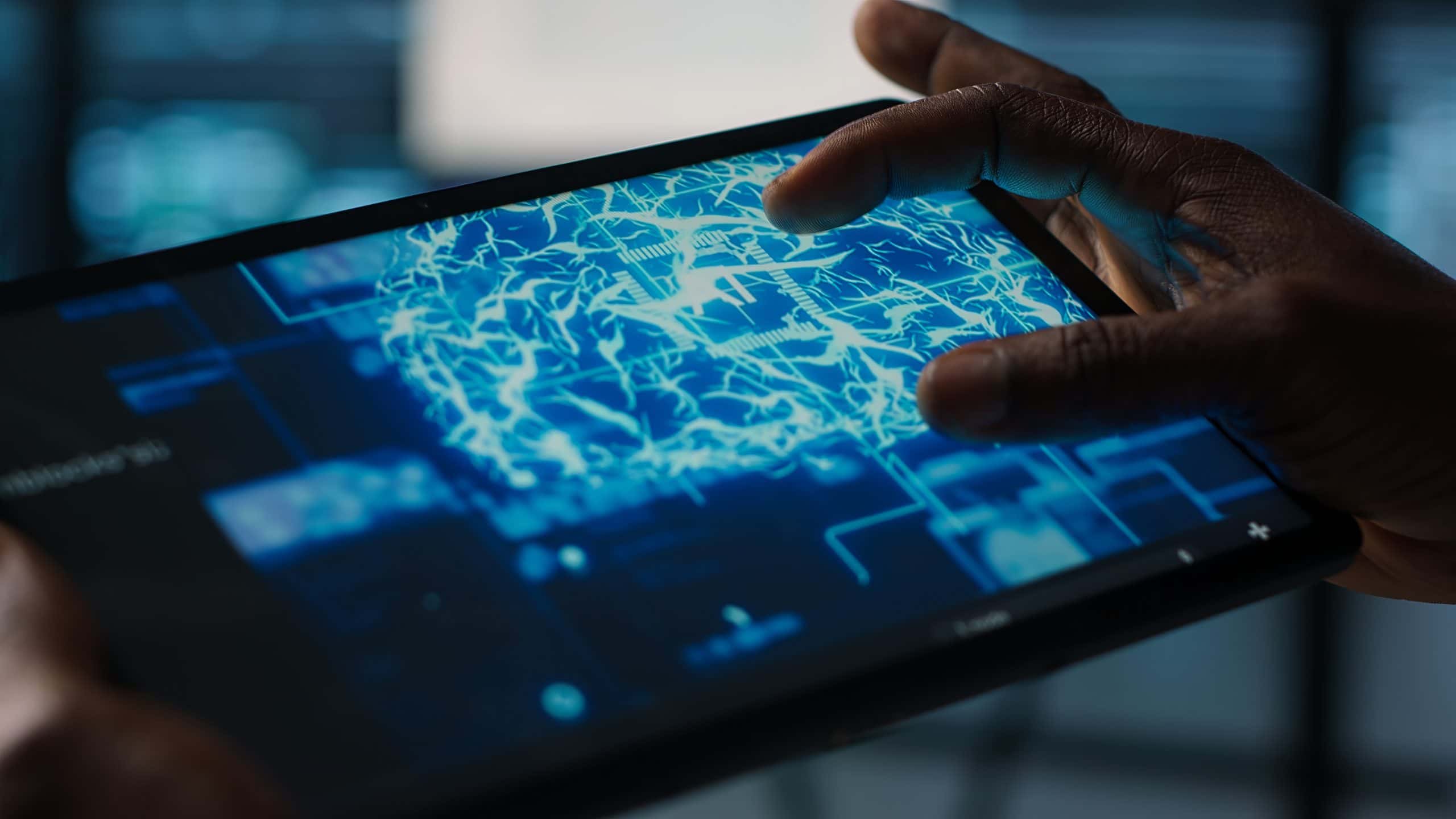 Close up of computer scientist in data center uses AI on tablet