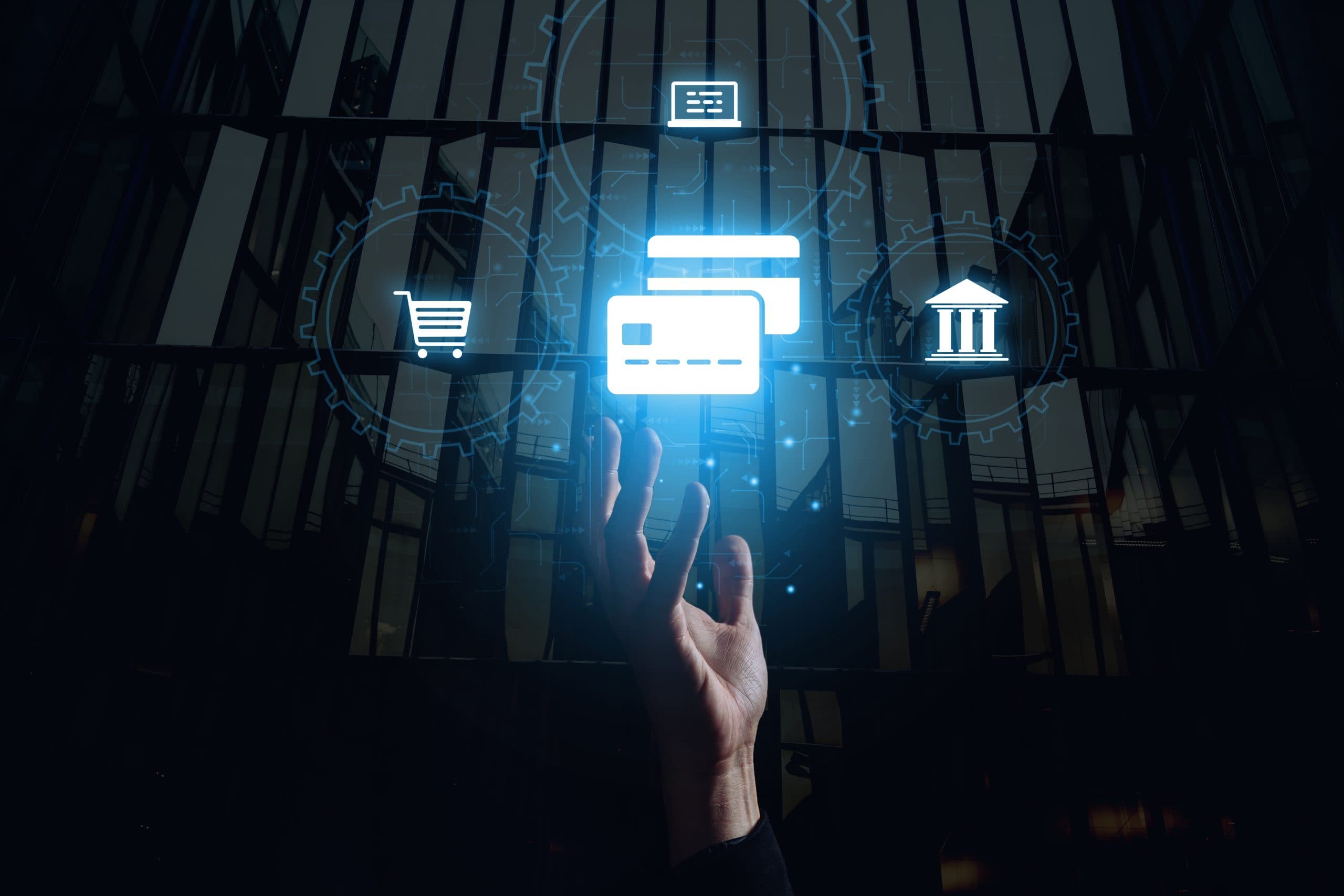 The concept of paying for services with a bank card online. The hand reaches for the hologram.