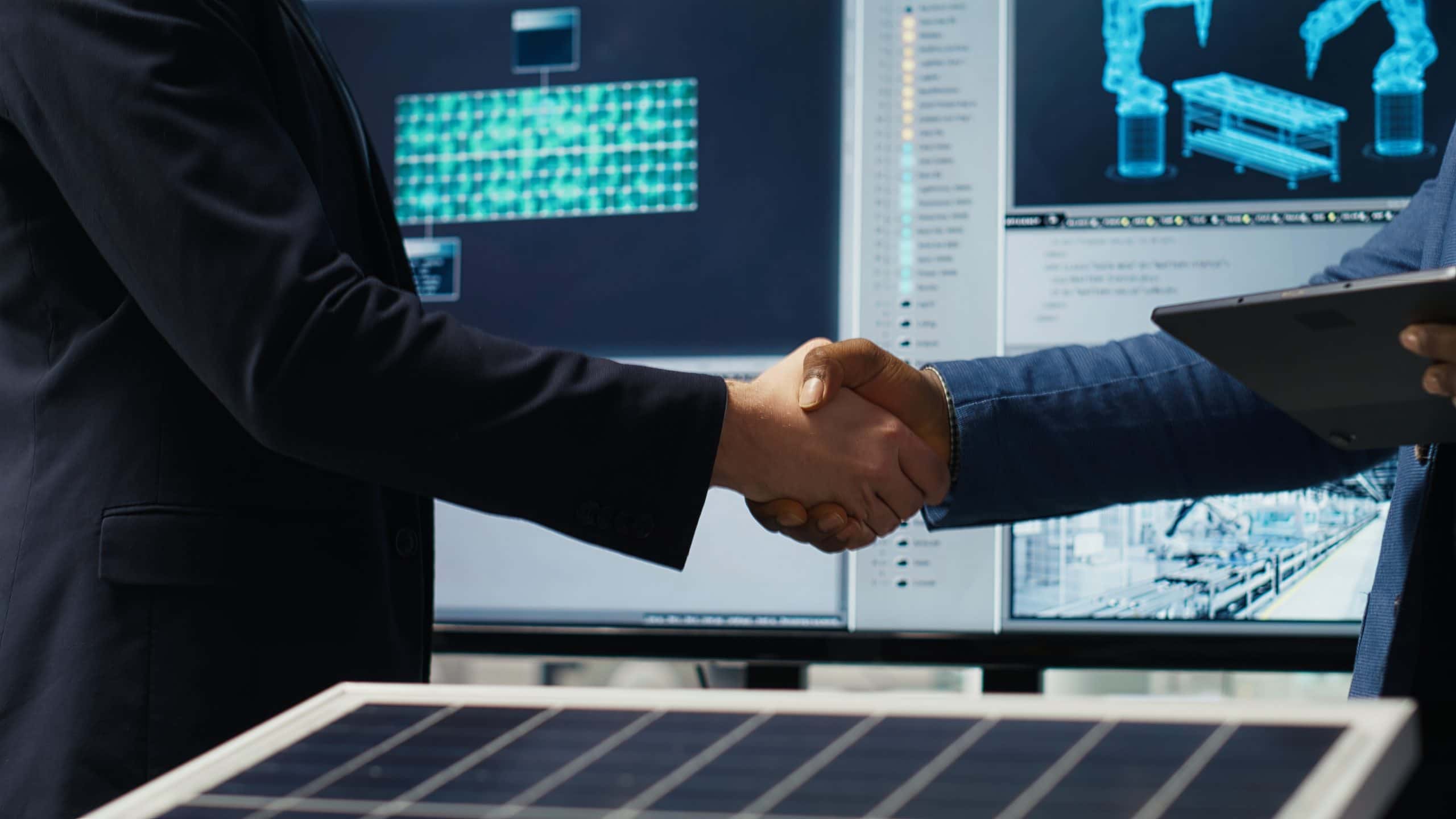 Factory manager shakes hands with investor, working to expand production